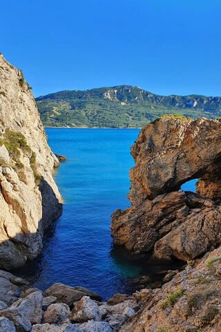 Nature's Gateway: Rocks Embracing the Sea 🌊🏞️