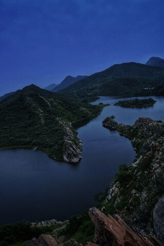 Mystical Serenity: The Night Sky Over Majestic Mountains