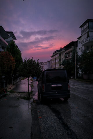 Midnight Drive: A Black Car on Rainy Streets