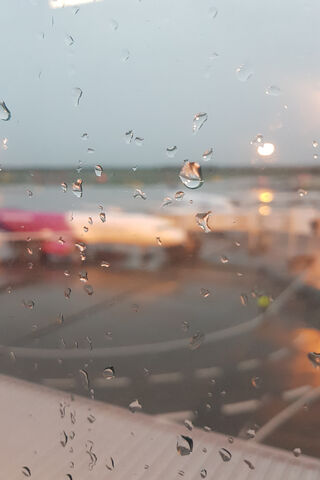 Raindrops on the Runway: A Window to Adventure ✈️💧