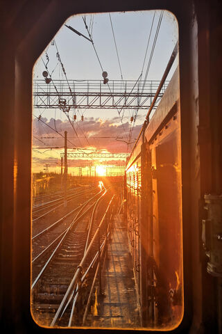 Golden Horizons: A Train Journey at Dusk