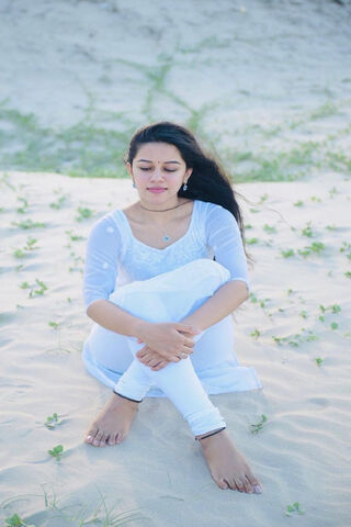 Serenity in White: Mirnalini Ravi's Tranquil Moment