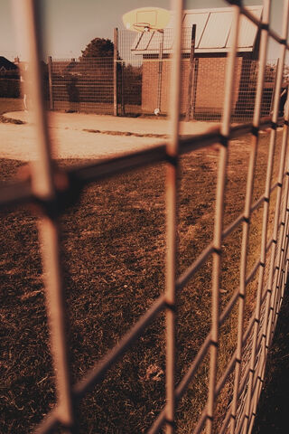 Behind the Fence: A Game Awaits 🏀