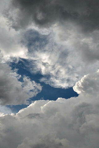 A Glimpse of Serenity: The Blue Sky Amidst the Clouds 🌤️