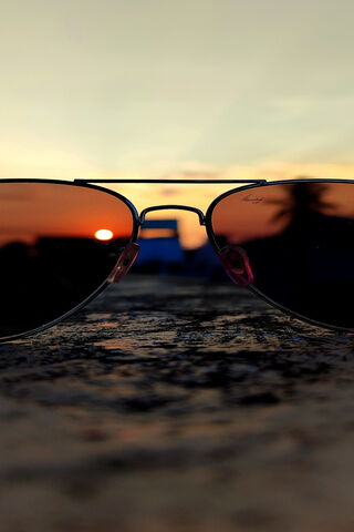 Sunset Reflections: A Glimpse Through Shades 🌅🕶️