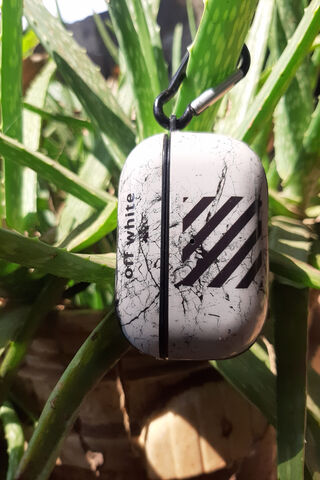 Stylish Sound: Off-White AirPods in Nature 🎧🌿