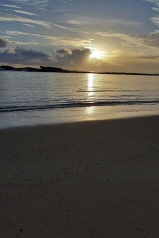 Morning Glow: A Serene Beach Awakening 🌅