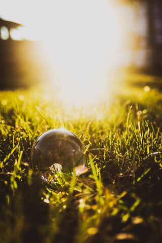 Sunlit Serenity: A Glass Sphere on Nature's Canvas