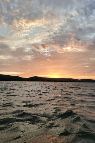 Evening Glow Over Tranquil Waters 🌅