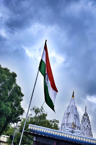 Waving Pride: The Indian Flag Against a Majestic Sky 🇮🇳