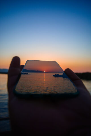 Sunset Reflections: A Digital Embrace 🌅📱