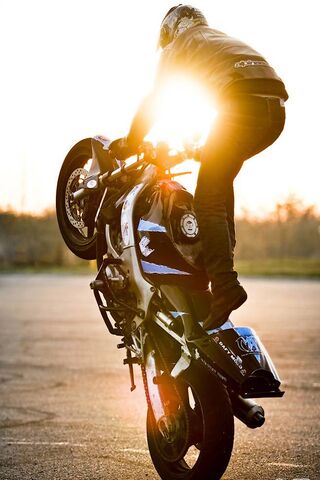 Sunset Thrills: The Art of Stunt Riding 🌅🏍️