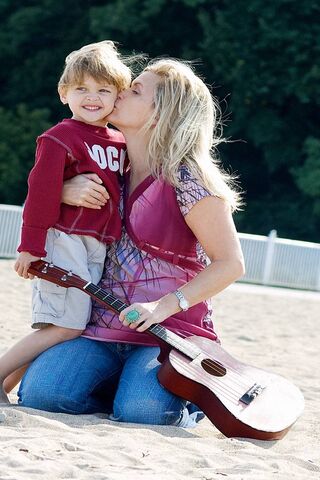 Joyful Moments: A Mother and Son Bonding on the Beach 🎶❤️