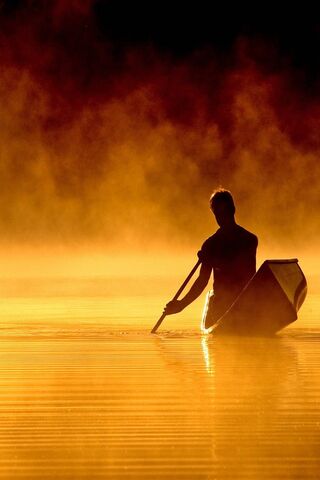 Golden Serenity: The Boatman's Journey