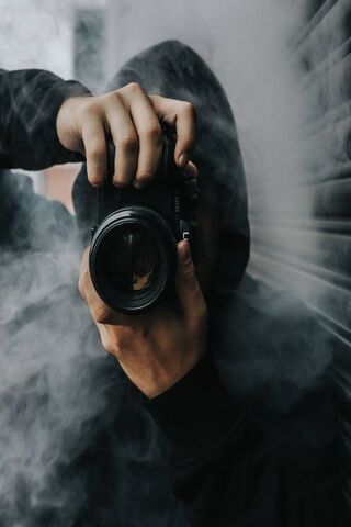 A Person Holding Black DSLR Camera · Free Stock Photo