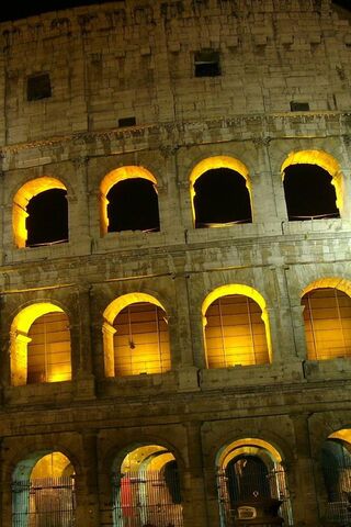 The Majestic Glow of the Colosseum at Night 🌙🏛️