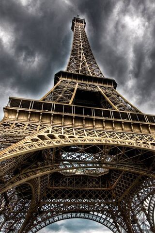 Eiffel Tower: A Majestic Marvel Under Stormy Skies 🌩️