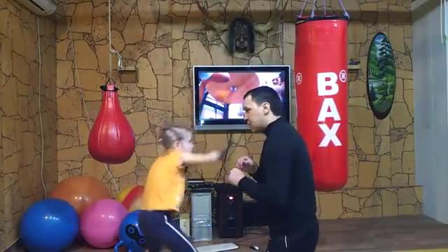 Little girl boxing with her father