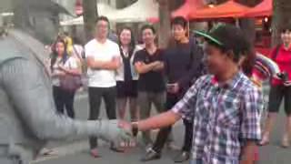 Guy gets punched by street performer