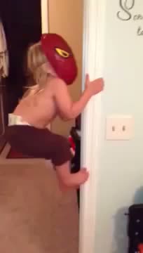 Little Girl In Spider Man Mask Climbs Door